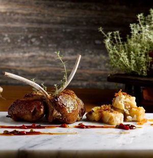 Grilled Lamb Rack in Honey Dressing Served with Carrot Cake & Pork Sausage
