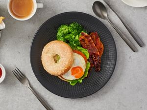 Toasted Sesame Bagel with Avocado, Sunny-Side Up and Maple Bacon