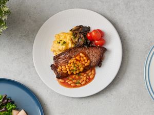 Ribeye Steak with Scrambled Eggs, Wilted Spinach, Mushrooms, Cherry Tomatoes and Baked Beans